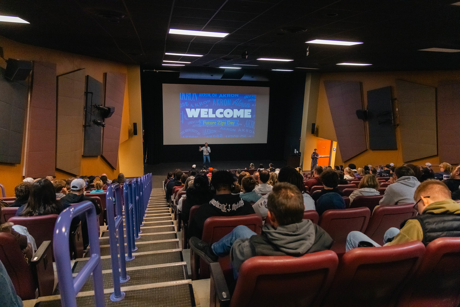 Univeristy image dipicitng new students listening to a speaker in a lecture hall